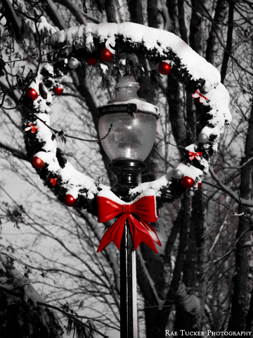 A wreath encircles a lamp post during the holiday season.