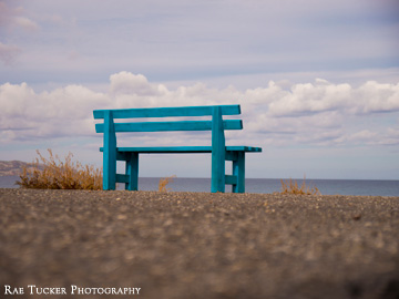 A blue bench overlooks the Aegean Sea in Kissamos, Crete