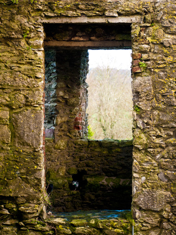 A window in a stone tower of the Blarney Castle during the winter.