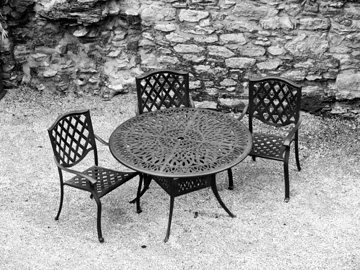 A table and chairs inside a stone castle in Ireland.
