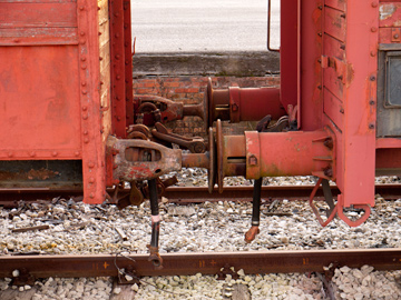 Two rusted train cars coupled.