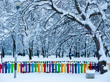 A colorful playground fence stands out amongst the snow in Sofia, Bulgaria