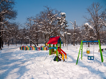 The sun shines over a colorful playground covered in snow in Sofia, Bulgaria