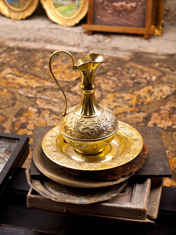 An antique, brass pitcher sits on a pile of photo frames in the Old Bazaar in Skopje, Macedonia