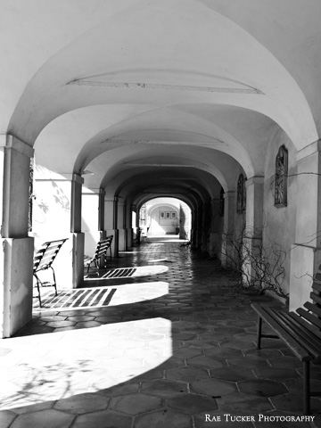 Light and shadows in a black and white image of a covered walkway in the South Bohemia region of Czechia