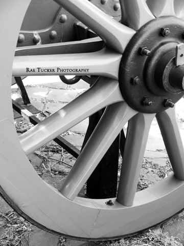 A soft, black and white image of a wagon wheel