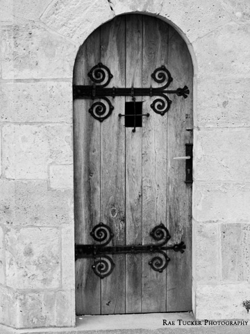 A black and white image of an old, wooden door in Budapest, Hungary