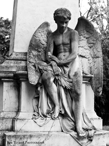 A stone angel in mourning at a cemetery in Budapest, Hungary