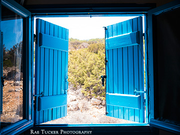 Looking outside through blue shutters