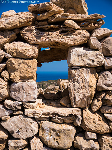 A rock wall provides a window overlooking the Libyan Sea on the island of Gavdos in Greece.