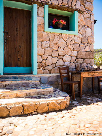 A stone building with a wooden table in Greece