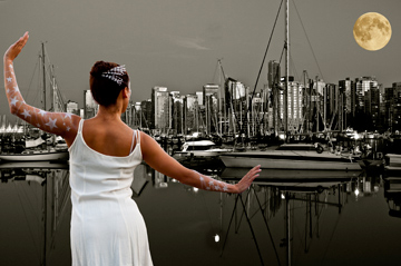 A ballerina dancing under the super moon in front of the Vancouver skyline and harbour
