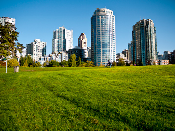 A man cycles through a park in Yaletown in Vancouver, British Columbia