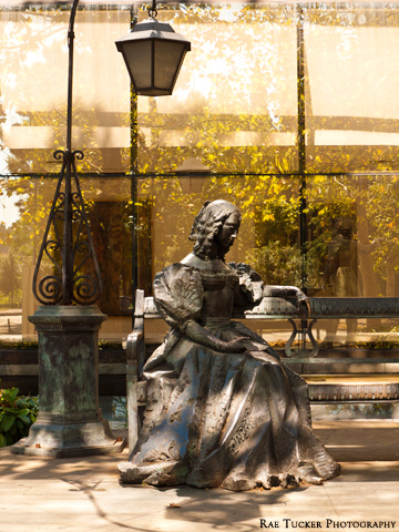 A statue of a woman on a bench in Podgorica, Montenegro