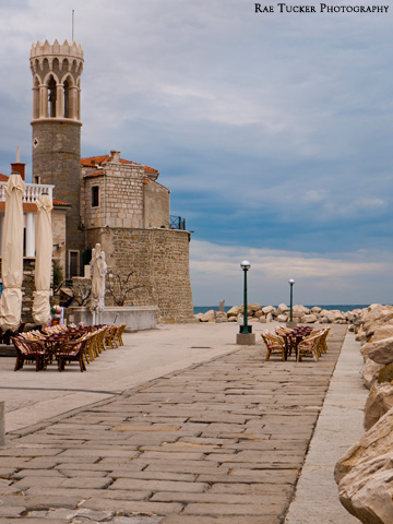 Patios, the church and lighthouse in Piran, Slovenia