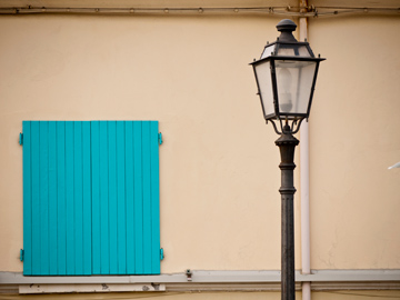 A street light and wooden shuttered window in Cesenatico, Italy