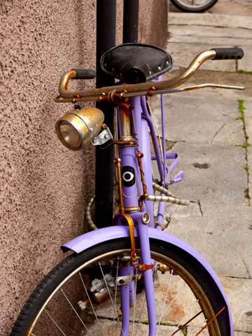A purple bicycle in Parma, Italy
