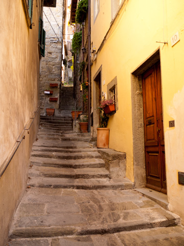 A small staired street climbs up in Cortona, Italy