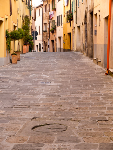 A cobblestone, residential street in Montepulciano, Italy.