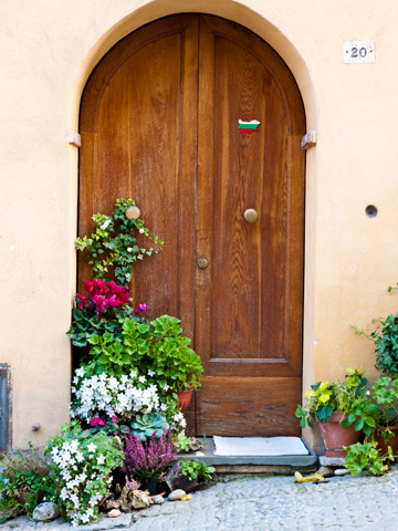 In Montepulciano, Italy an entrance is decorated with plants, flowers and a Bulgarian flag sticker