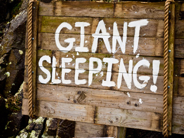 A wooden sign warns of a sleeping giant in Ireland.