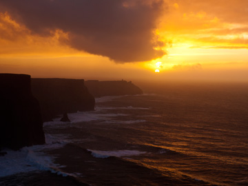 The sun sets over the Cliffs of Moher in Ireland