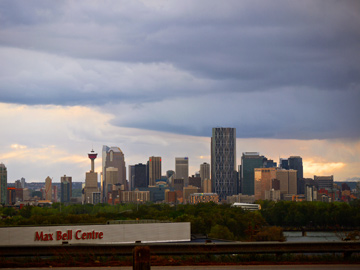 Max Bell Centre sits in front of the downtown skyline of Calgary, Alberta