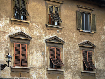Windows & shutters adorn this apartment building in Florence