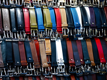 Belts displayed at a market stall in Florence, Italy
