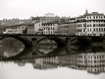 A bridge and buildings along the Arno River in Florence, Italy