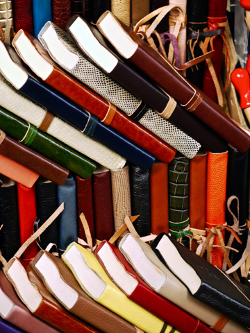 Leather-bound journals on display at a market stall in Florence, Italy