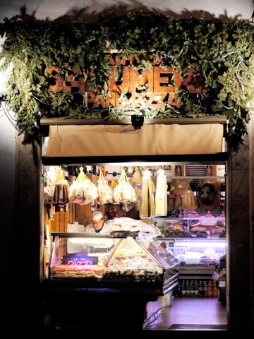 Pasta, meats and cheeses are on display at this small market shop in Rome, Italy
