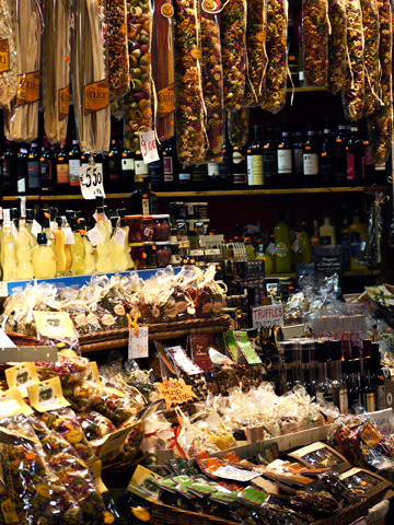 A stall selling pasta, wine and truffles to tourists in the San Lorenzo Market in Florence, Italy