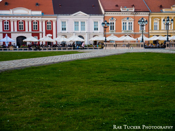 Buildings and patios lining Unity Square in Timisoara, Romania