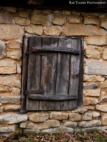 An old wooden shutter on a stone shed found in the Village Museum in Bucharest, Romania.