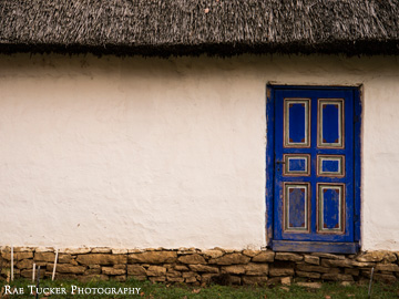 A blue painted door stands out on this house found in the Village Museum in Bucharest, Romania