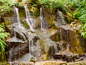 Water falls over a rocky ledge in Ireland.