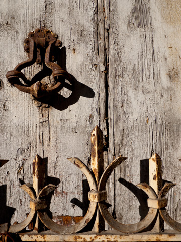 An old door and rusted fence in Bologna, Italy