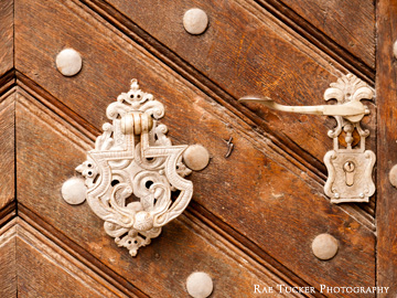 An antique door knocker, handle and lock in Prague, Czech Republic.