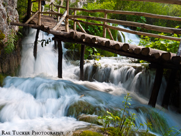 Water rushes under a wooden boardwalk in Croatia