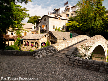 The Crooked Bridge is flanked by stone buildings in the old town in Mostar, BiH