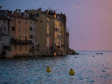 Pinks and purples glow from the setting sun in Rovigno, Croatia
