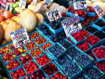 Fresh berries, tomatoes and melons on display