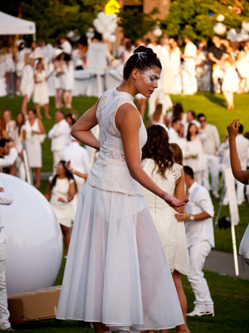A dancer posing at an event in the park.