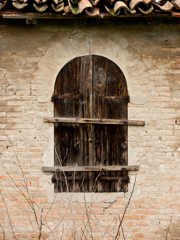 Wooden shutters borded up on a shed in Italy