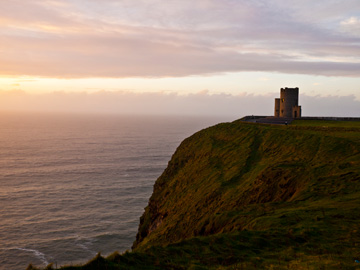 A round stone building overlooks the Cliffs of Moher in Ireland.