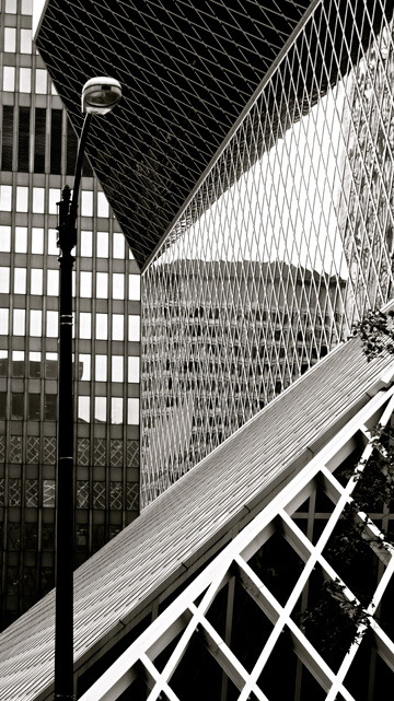 The public library building has unique architectural elements compared to the buildings that surround it in Seattle, USA
